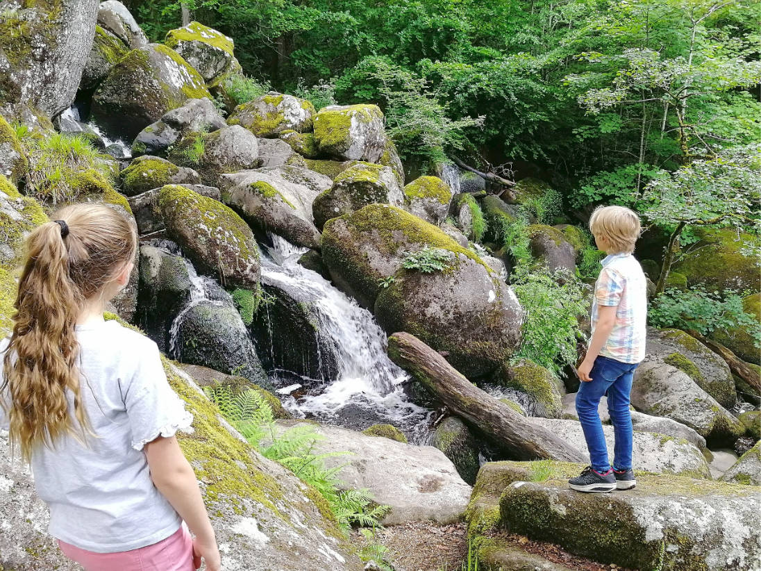 children looking at waterfall